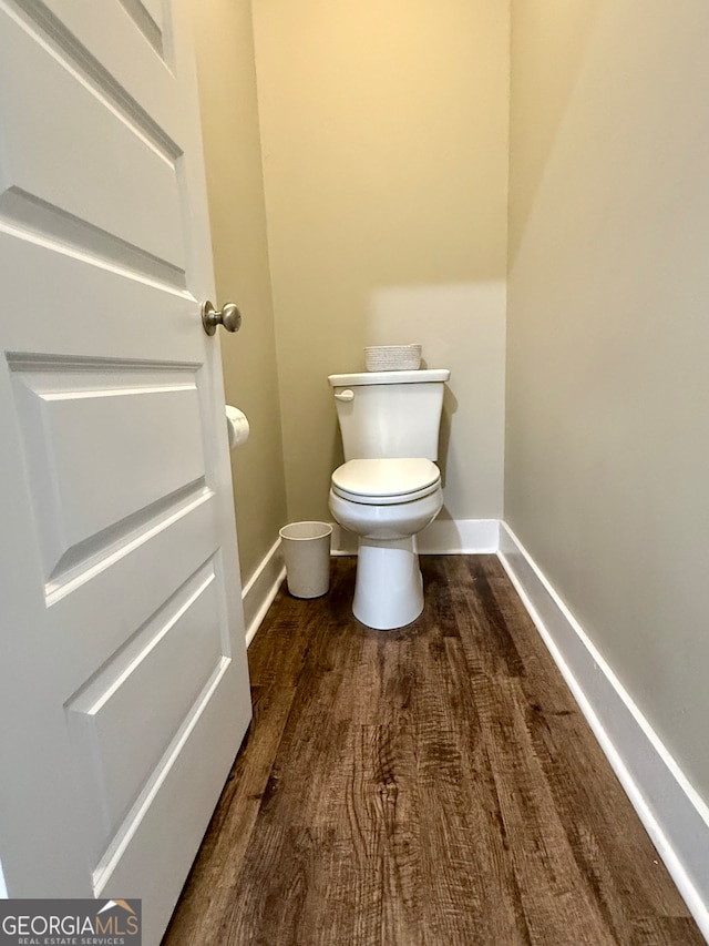 bathroom featuring hardwood / wood-style floors and toilet