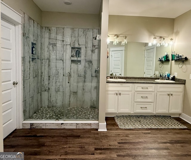 bathroom featuring a shower with door, vanity, and hardwood / wood-style flooring