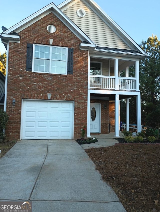 view of front facade with a garage and a balcony