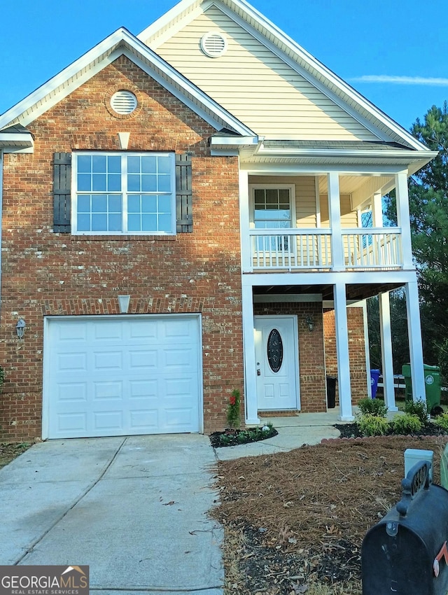 view of front of home with a garage, covered porch, concrete driveway, and brick siding