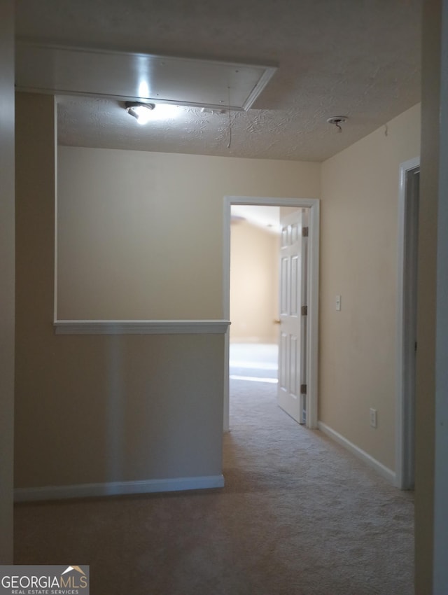 hallway with light colored carpet