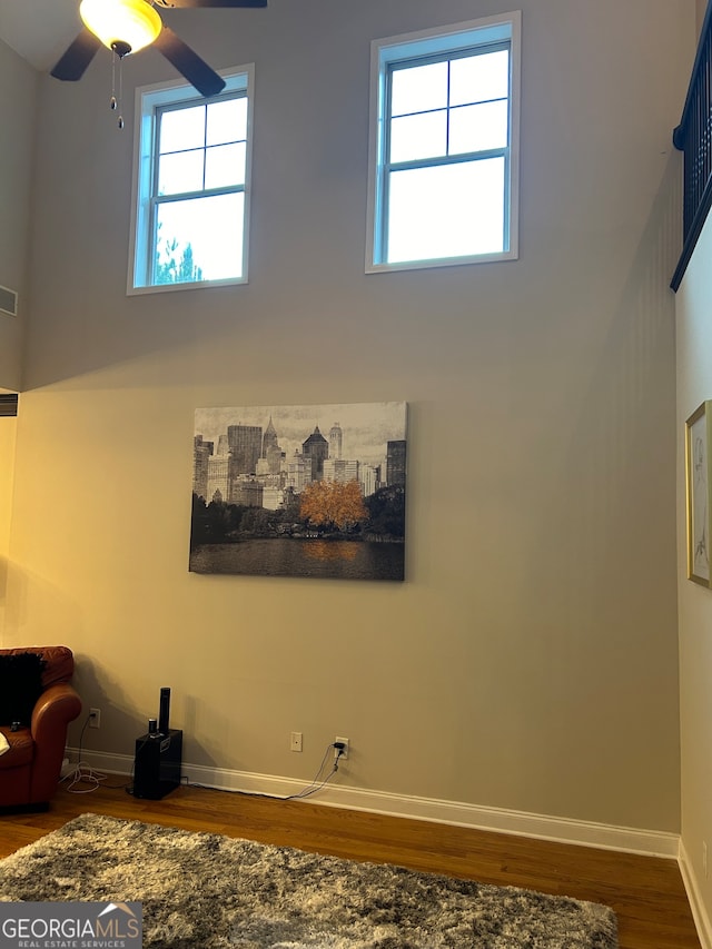 unfurnished living room featuring dark hardwood / wood-style floors, a wealth of natural light, and ceiling fan