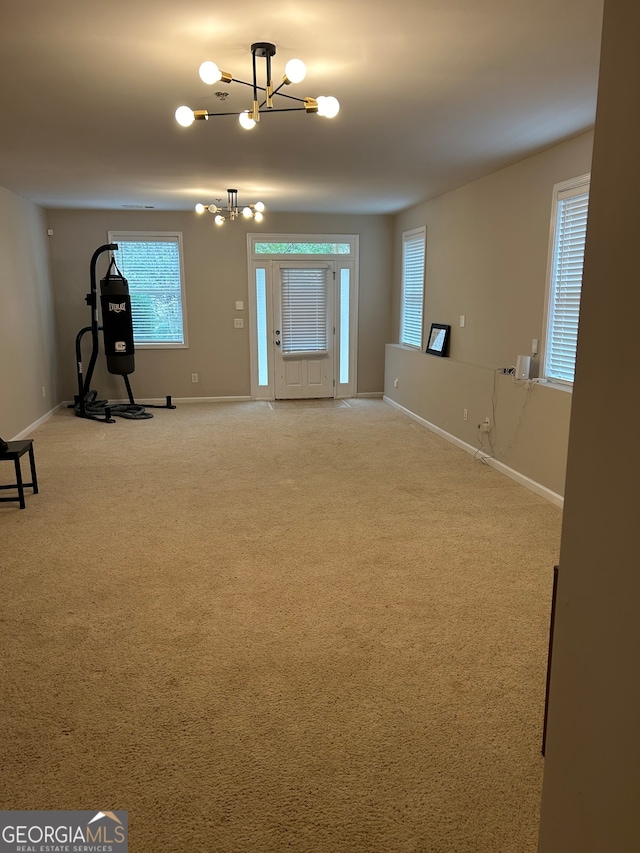 interior space with carpet flooring and an inviting chandelier