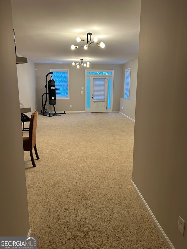 interior space with a chandelier and carpet floors