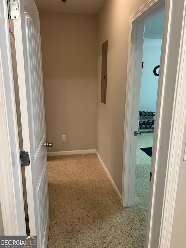 corridor featuring light carpet and electric panel