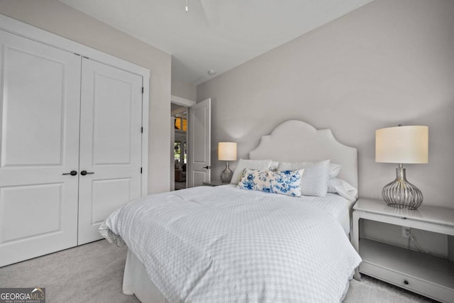 bedroom featuring light carpet and a closet