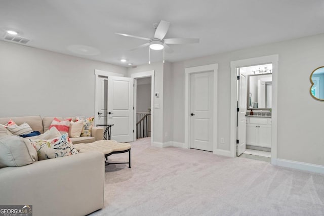 carpeted living room with ceiling fan