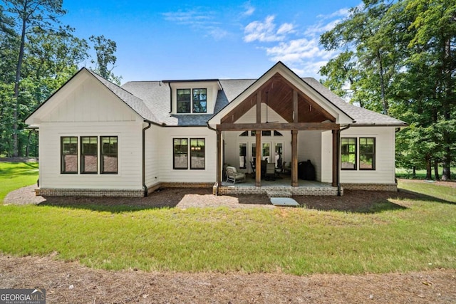 rear view of property featuring a lawn