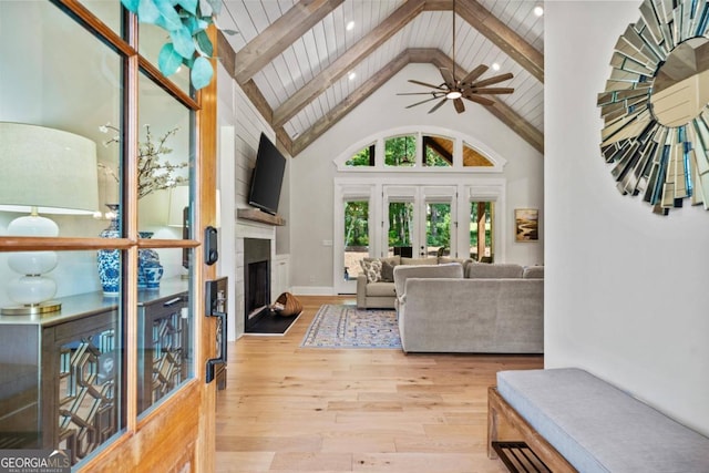 living room with beam ceiling, ceiling fan, wooden ceiling, high vaulted ceiling, and light wood-type flooring