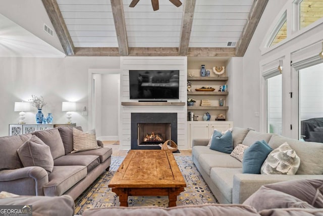 living room with hardwood / wood-style flooring, lofted ceiling with beams, ceiling fan, and a fireplace