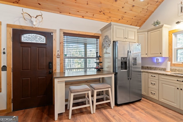 kitchen with stainless steel fridge, wood ceiling, lofted ceiling, and light wood-type flooring