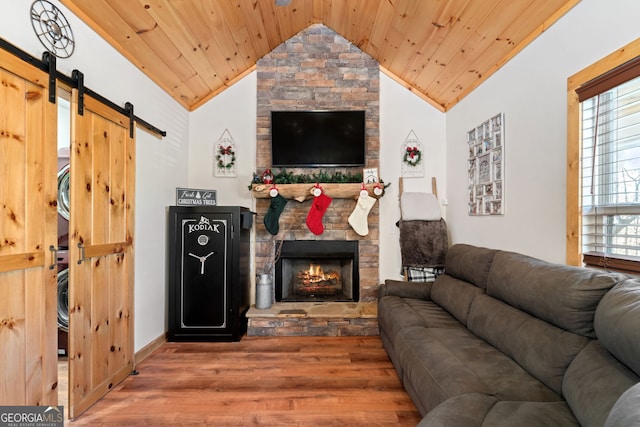 living room with hardwood / wood-style floors, wood ceiling, a fireplace, and vaulted ceiling