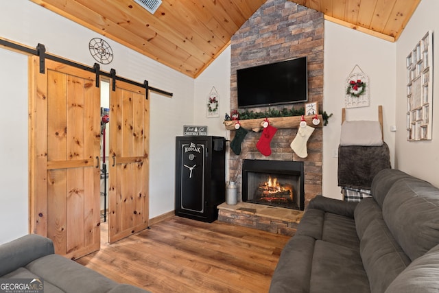 living room with wood-type flooring, wooden ceiling, a fireplace, and vaulted ceiling