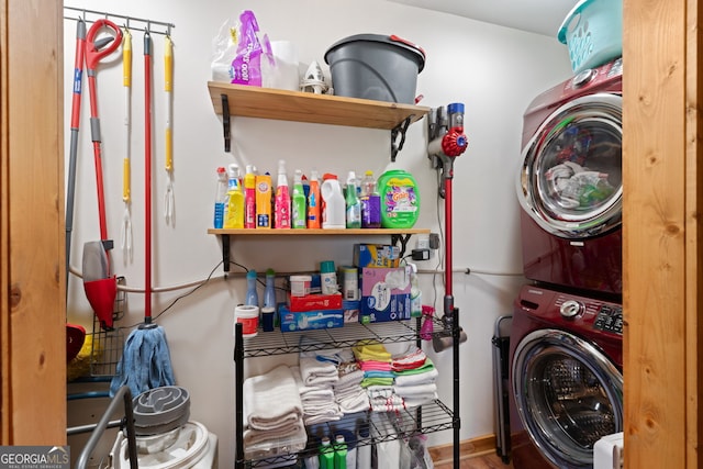 washroom with hardwood / wood-style flooring and stacked washing maching and dryer