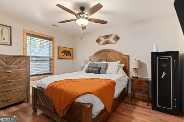 bedroom featuring ceiling fan and dark hardwood / wood-style floors