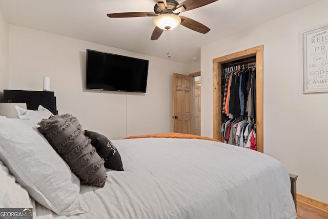 bedroom with ceiling fan, a closet, and hardwood / wood-style flooring