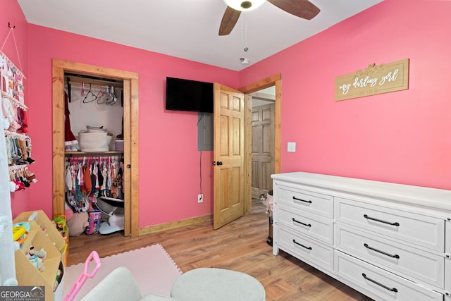 bedroom featuring ceiling fan, light wood-type flooring, and a closet