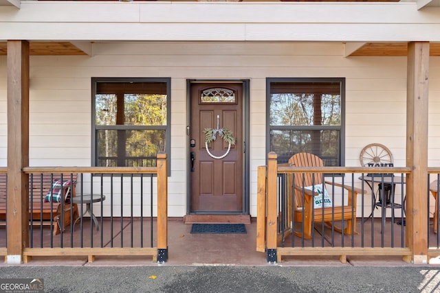 view of exterior entry with covered porch