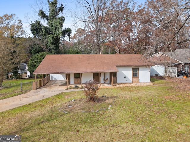 ranch-style house featuring a carport and a front yard