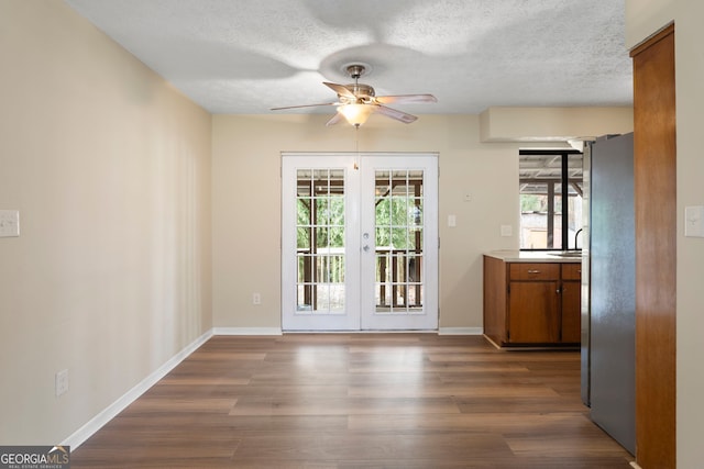 entryway featuring sink, ceiling fan, a textured ceiling, dark hardwood / wood-style flooring, and french doors