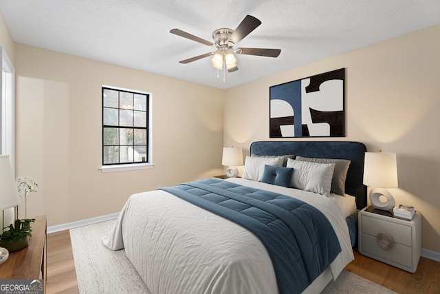 bedroom featuring hardwood / wood-style floors and ceiling fan