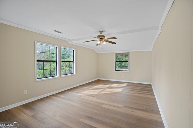 spare room with crown molding, ceiling fan, and light wood-type flooring