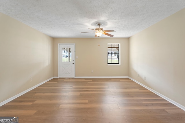 entrance foyer featuring hardwood / wood-style flooring, ceiling fan, and a textured ceiling