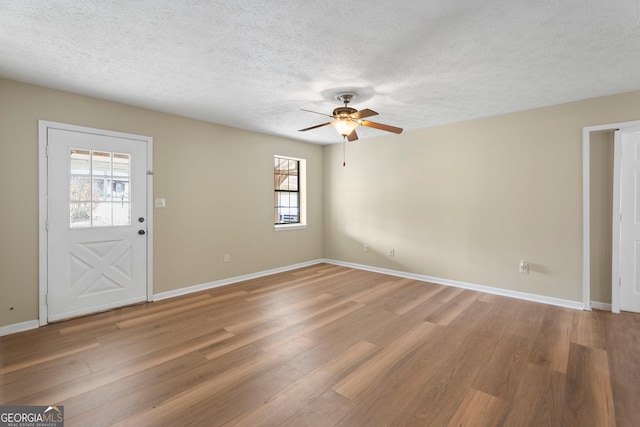 foyer entrance featuring hardwood / wood-style floors, a textured ceiling, and ceiling fan