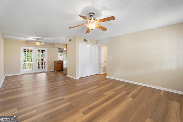 unfurnished living room featuring wood-type flooring and ceiling fan