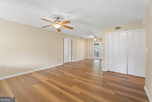 spare room with hardwood / wood-style floors and a textured ceiling