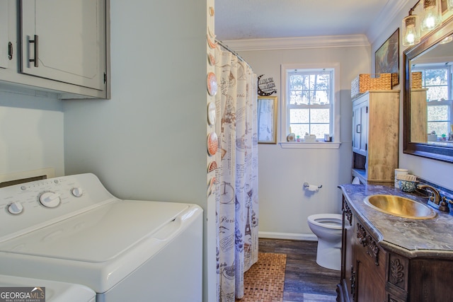 laundry area with dark hardwood / wood-style floors, crown molding, sink, and washing machine and clothes dryer