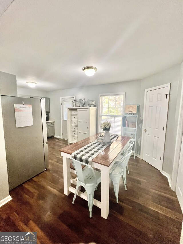 dining area featuring dark wood-type flooring