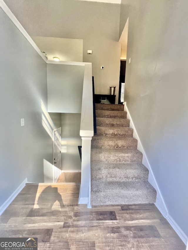 stairs with hardwood / wood-style flooring