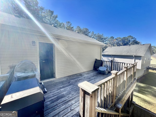 wooden deck with a grill