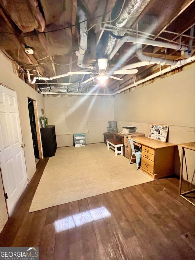 basement with hardwood / wood-style floors