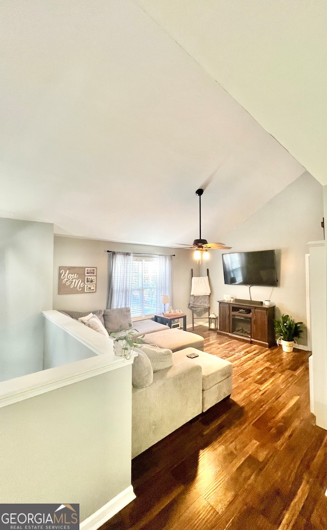 living room featuring hardwood / wood-style flooring, ceiling fan, and lofted ceiling