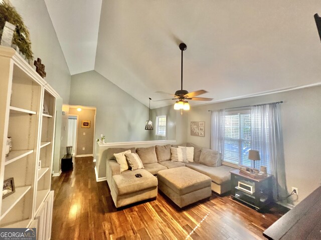 living room featuring hardwood / wood-style floors, ceiling fan, and vaulted ceiling