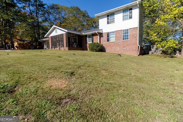 exterior space with a sunroom and a front yard