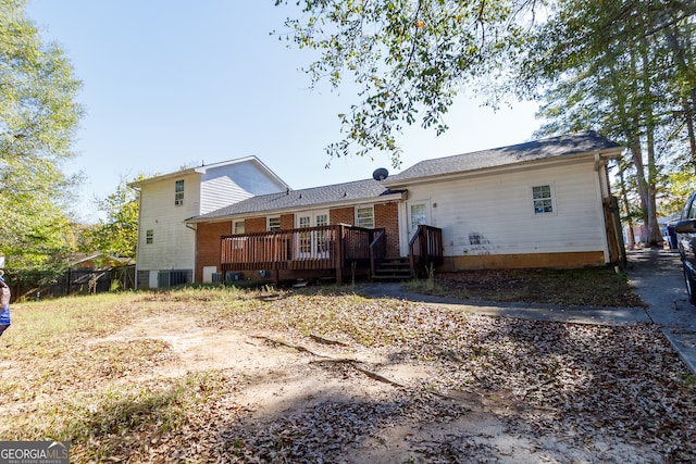 back of house with a wooden deck