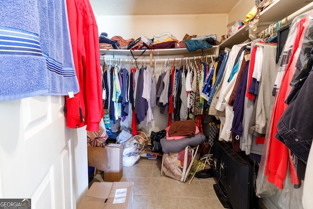 spacious closet with light tile patterned floors