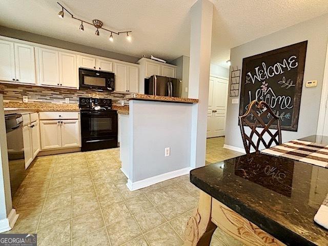 kitchen featuring backsplash, black appliances, light tile patterned floors, a textured ceiling, and white cabinetry