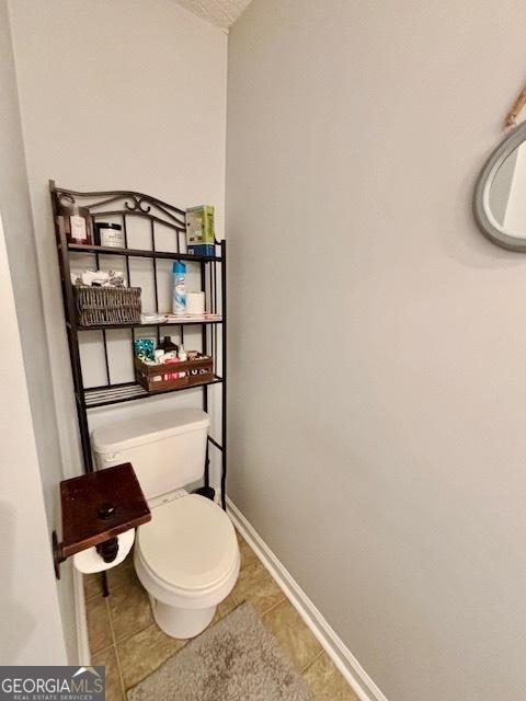 bathroom with tile patterned floors and toilet