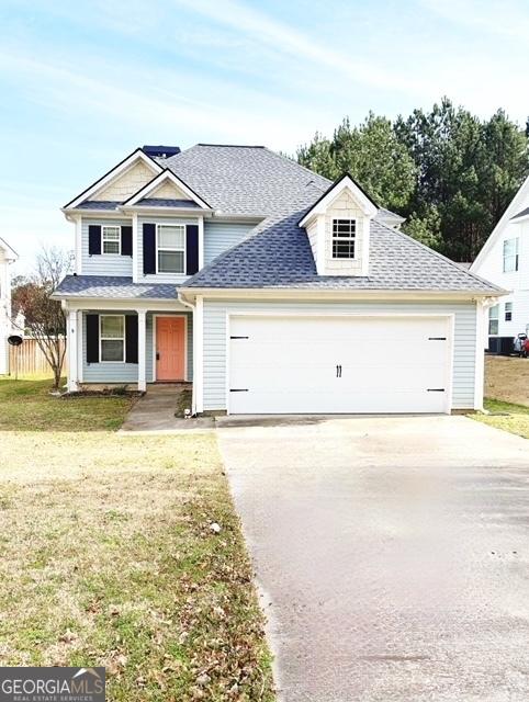 view of front facade with a garage and a front lawn