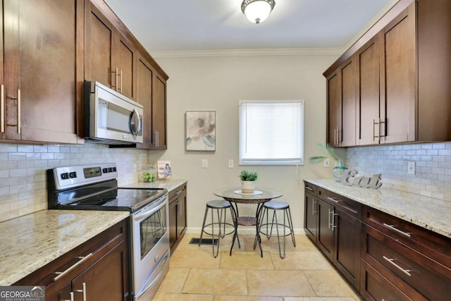 kitchen featuring light stone countertops, appliances with stainless steel finishes, tasteful backsplash, and crown molding