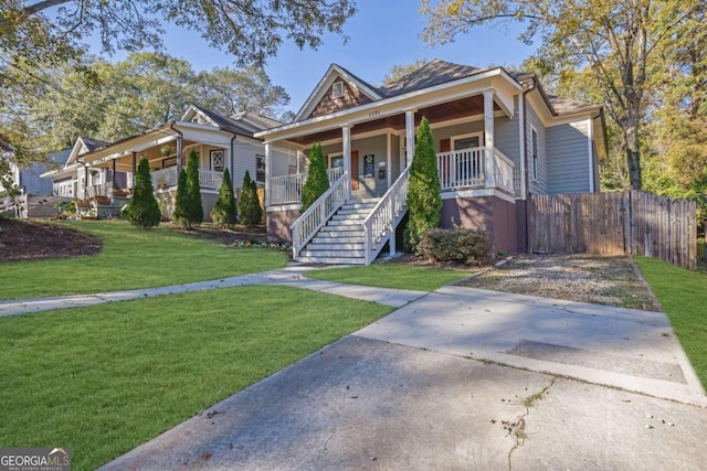 bungalow-style house with a porch and a front lawn