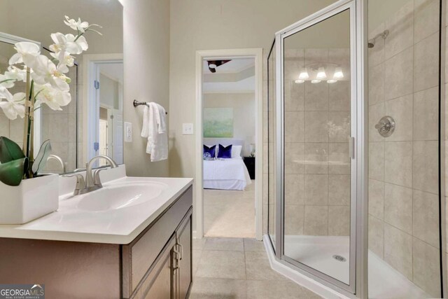 bathroom featuring tile patterned floors, vanity, and an enclosed shower