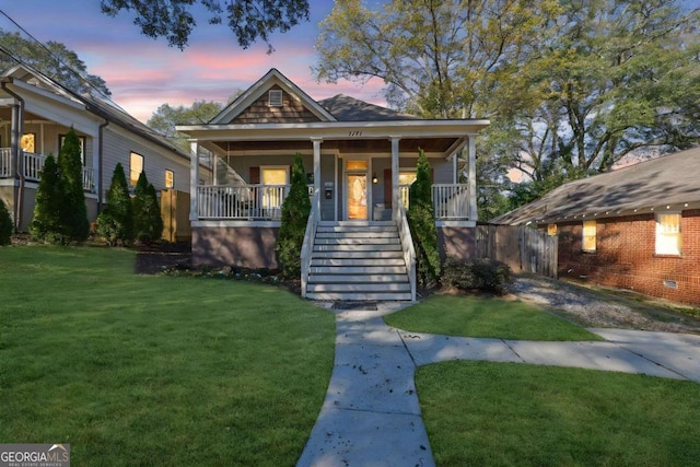 bungalow-style house featuring a yard and covered porch