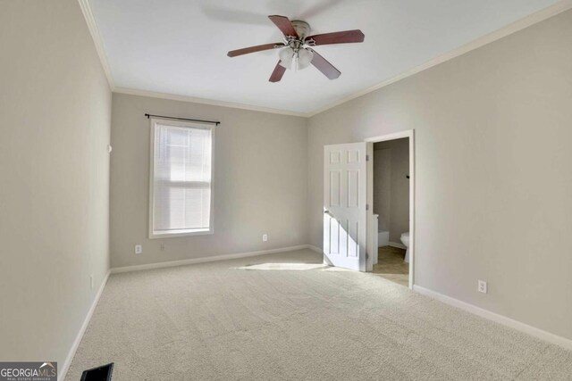 carpeted empty room with crown molding and ceiling fan