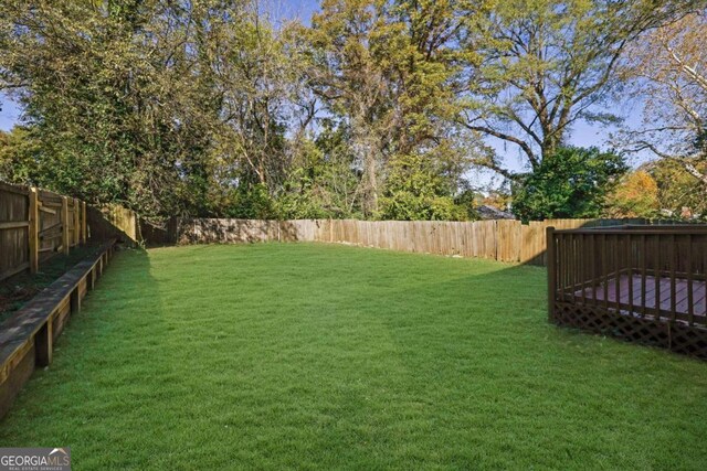 view of yard with a wooden deck