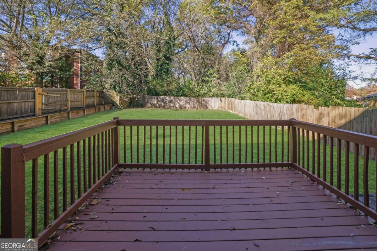 wooden deck featuring a lawn